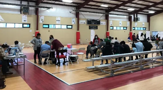 LatinX community members at the Williams Y get vaccines and documents
