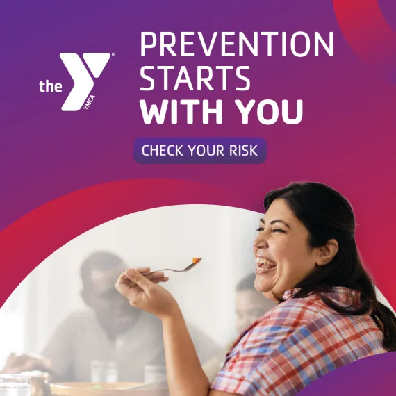A woman laughs while lifting a fork to her mouth. Above her, text reads 'Prevention starts with you. Check your risk' next to the YMCA logo.