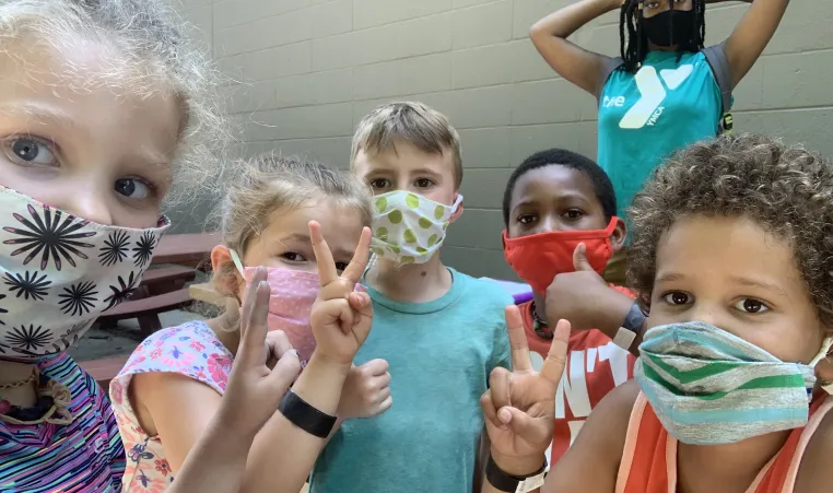 children together wearing masks at the Y