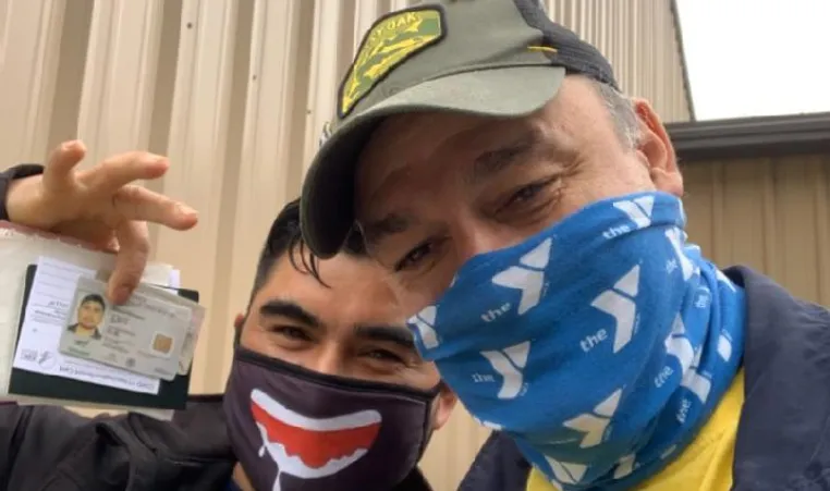 Latino man receives documents at the Y