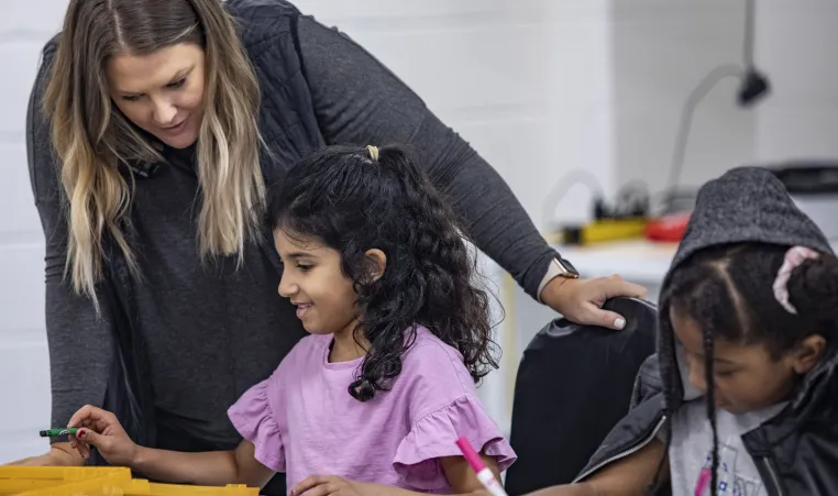 Y staff helping students in afterschool program