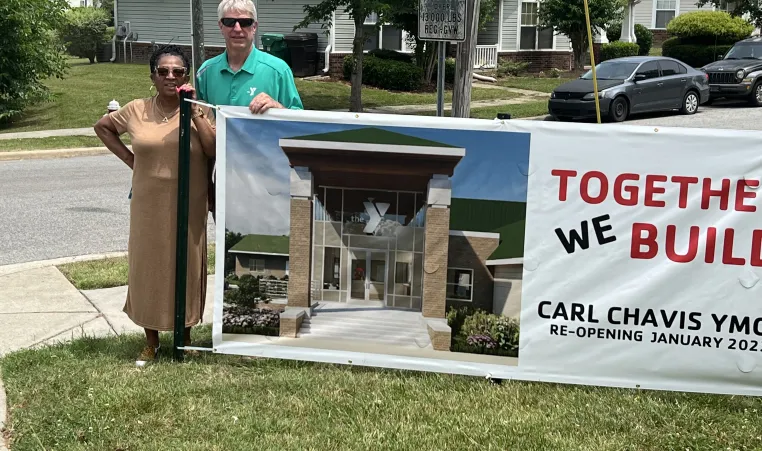 Carlvena Foster and Lynn Lomax  with banner