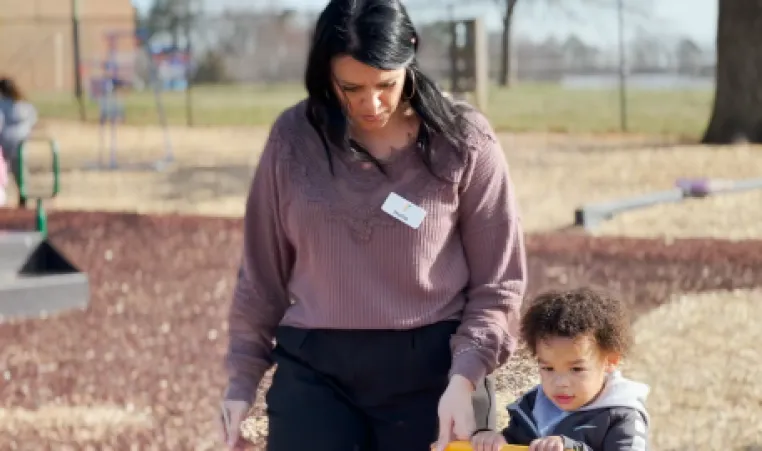 teacher and child on the playground