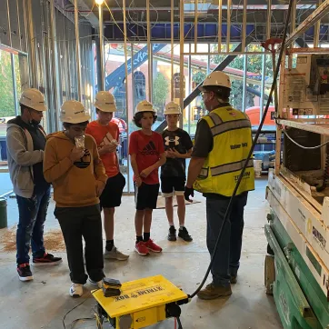wilson middle schoolers at the site of the new Foundation YMCA during Construction Academy Program