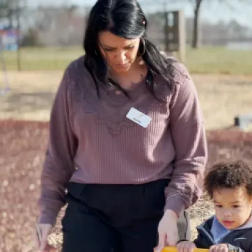 teacher and child on the playground